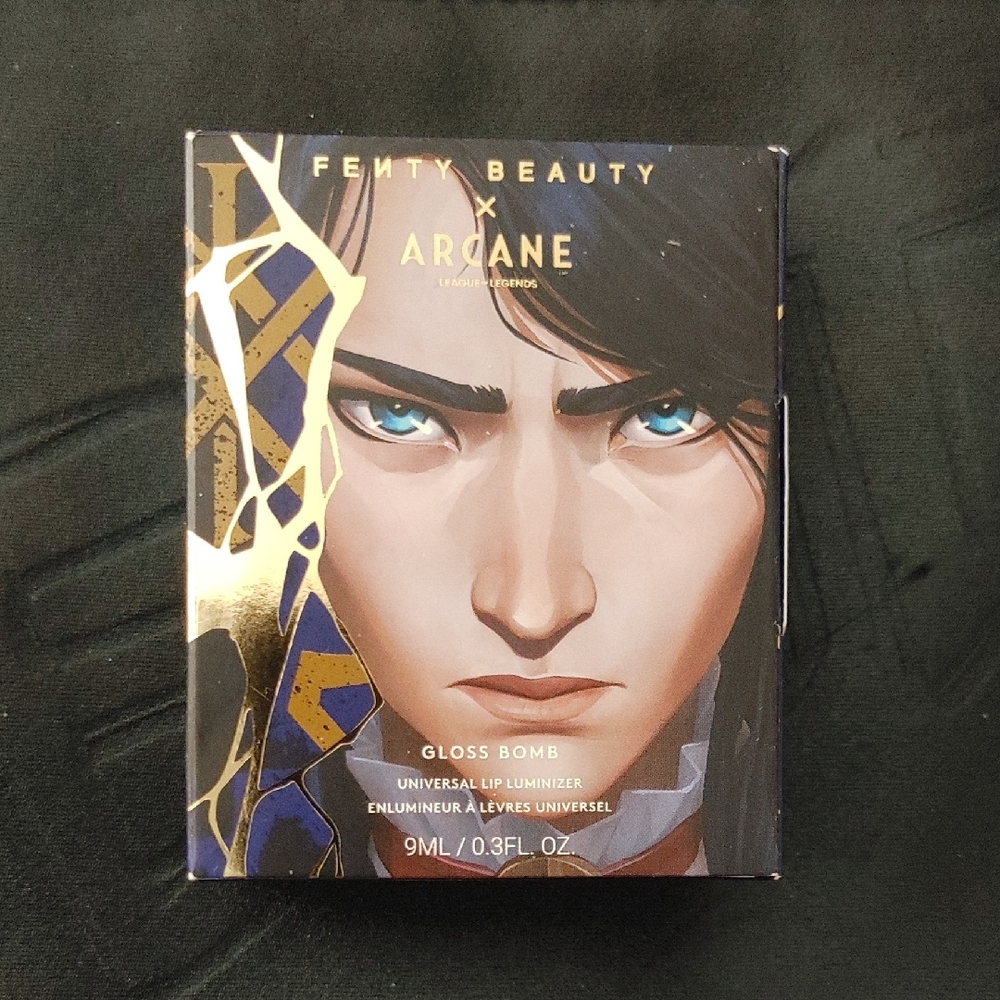 Fenty Beauty Arcane Gloss Bomb with Gold and Black Design
